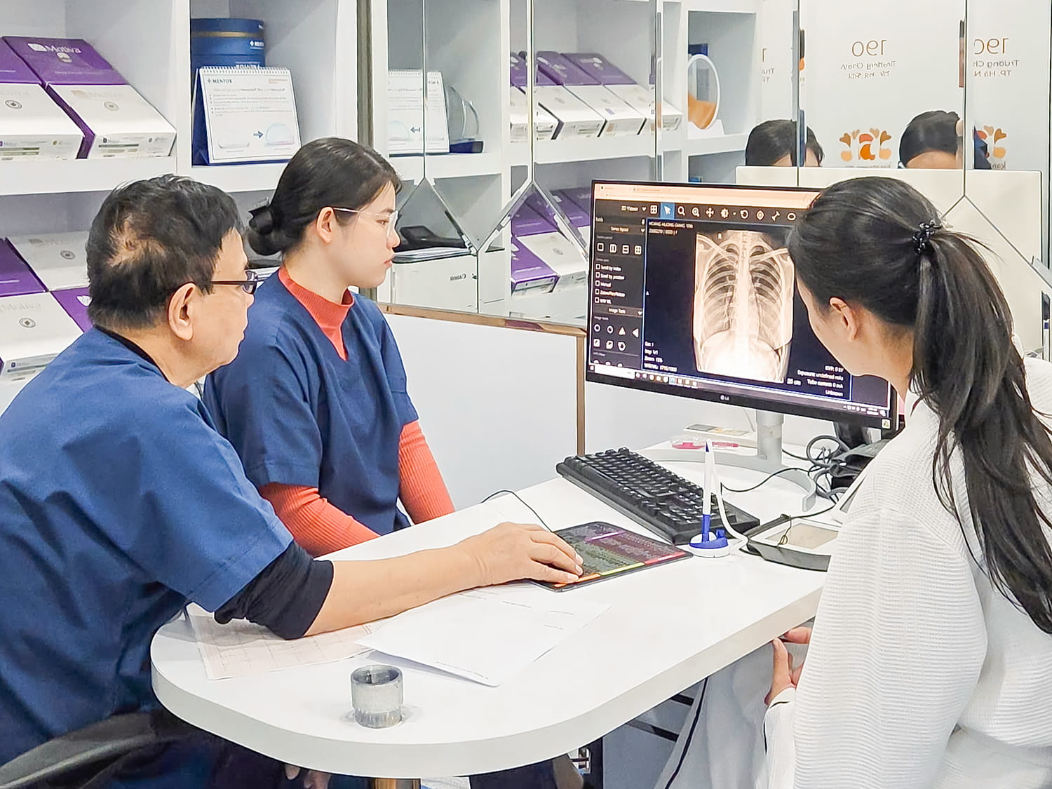 bác sĩ đang chỉ dẫn trên mô hình hoặc phim chụp X-quang để giải thích về độ an toàn