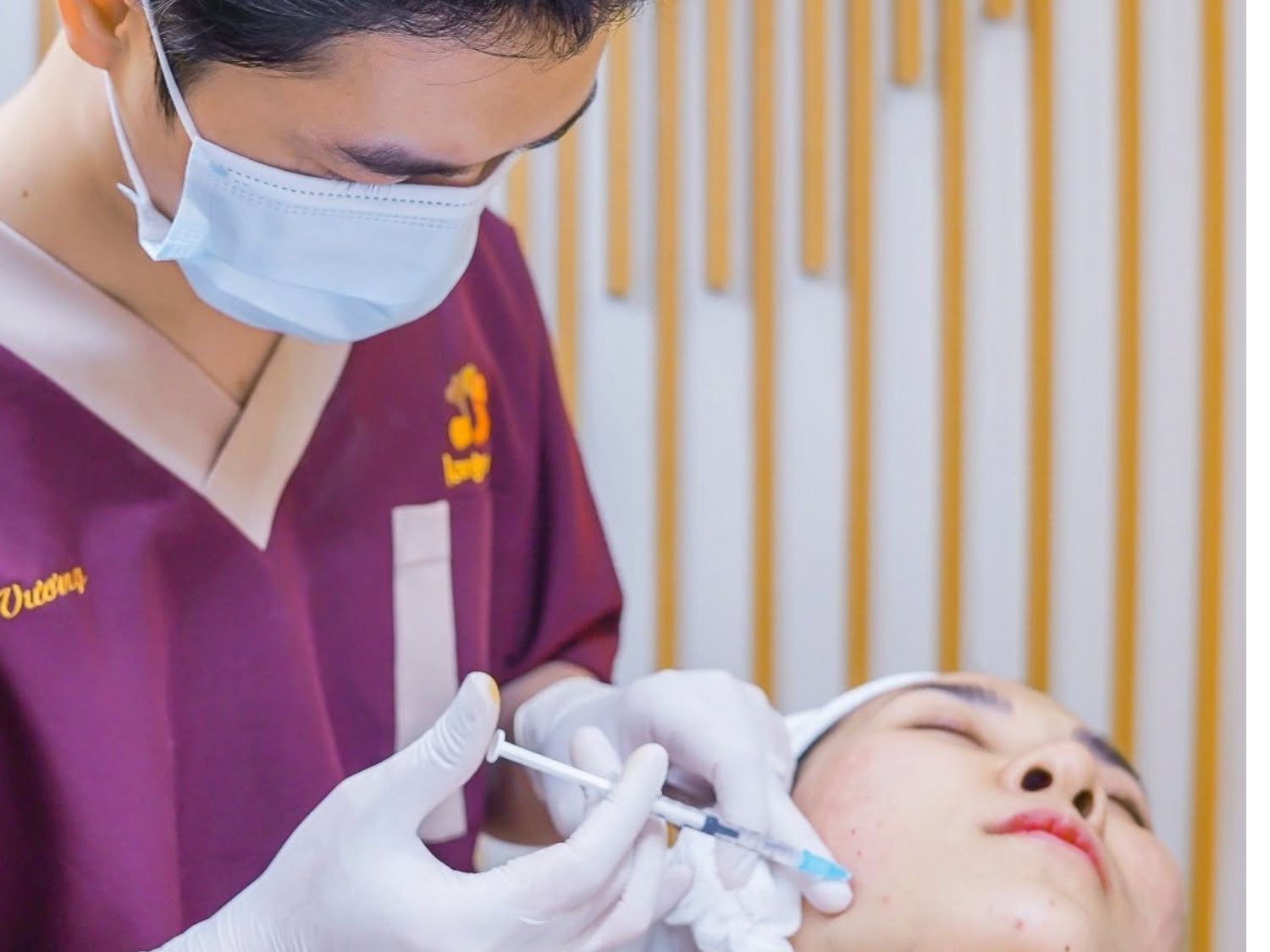 Hình ảnh bác sĩ Kangnam thực hiện thủ thuật tiêm vùng mặt cho khách hàng. Phương pháp và vị trí tiêm được lựa chọn dựa trên tình trạng da và chỉ định chuyên môn.